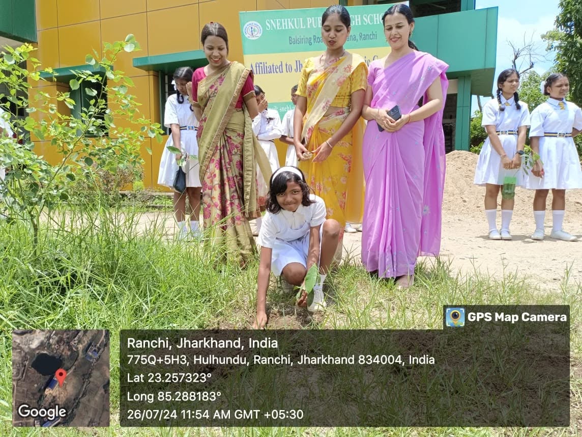 Teachers and Girl Students Planting Sapling